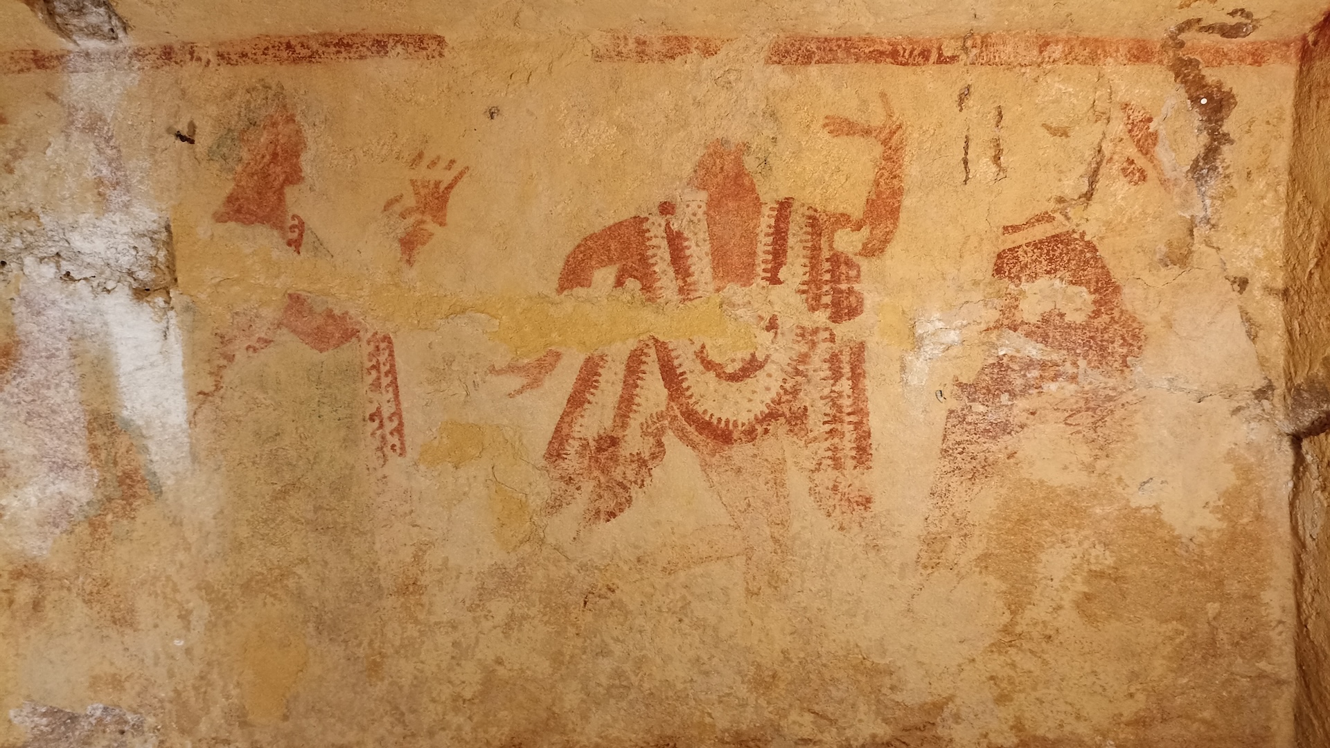 A wall painting showing dancing people on a tomb wall