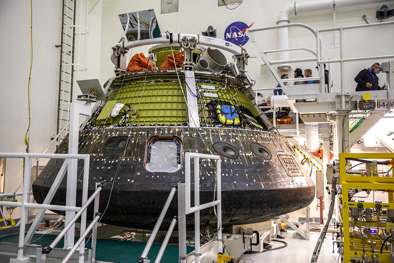 NASA's Artemis I Orion capsule is secured on a platform inside the Multi-Payload Processing Facility at the Kennedy Space Center in Florida. The spacecraft is now being unpacked of its equipment and undergoing post-flight engineering study.