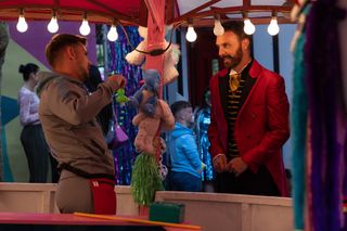 James is roped into helping out on a stall at the carnival in Hollyoaks.