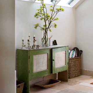 bathroom with white walls and green cabinet