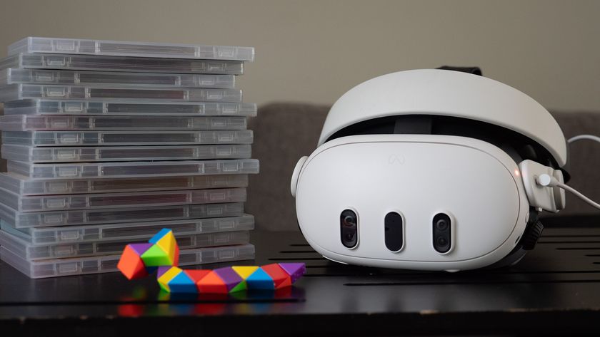 A Meta Quest 3 headset with a stack of game boxes next to it