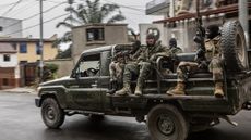 Members of the M23 rebel group riding in a vehicle formerly belonging to the Armed Forces of the Democratic Republic of Congo while patrolling a street in Goma 