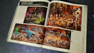 Necron example armies across two pages, sat on a starry background