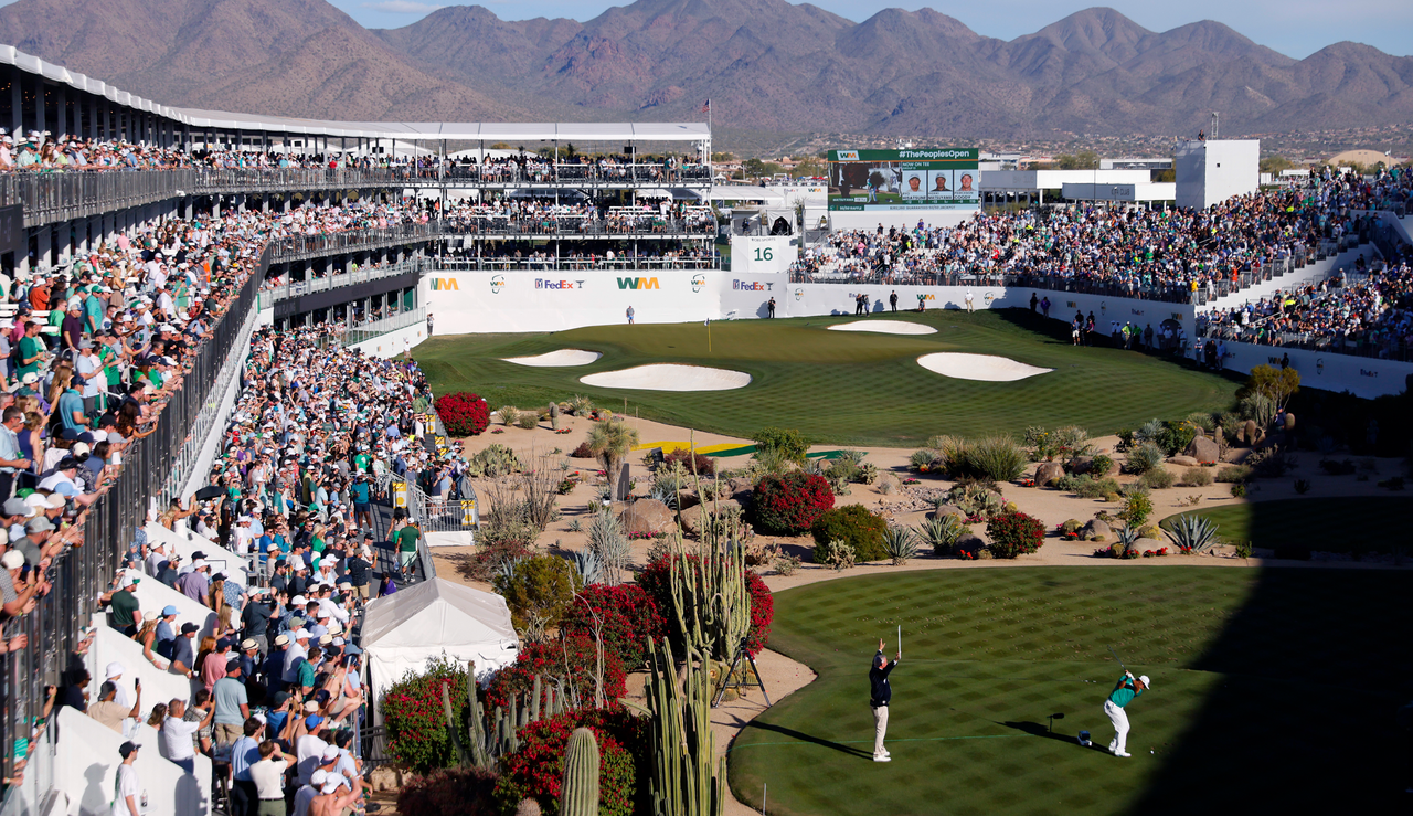 Hideki Matsuyama hits a chip shot at the 16th hole of the WM Phoenix Open