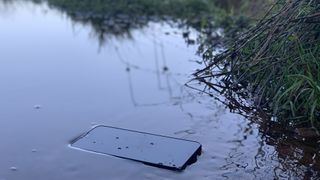 A phone lying in a puddle