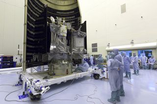 In the Payload Hazardous Servicing Facility at NASA's Kennedy Space Center in Florida, engineers and technicians pack the OSIRIS-REx probe into the payload fairing that will go atop an Atlas V rocket.