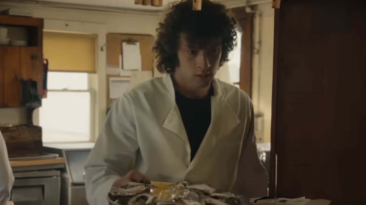Anthony laying out some food to be brought to a table
