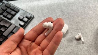 AirPods Pro (2nd generation) in the hands of the reviewer