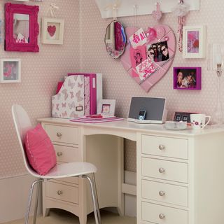 study room with pink wallpaper and white table
