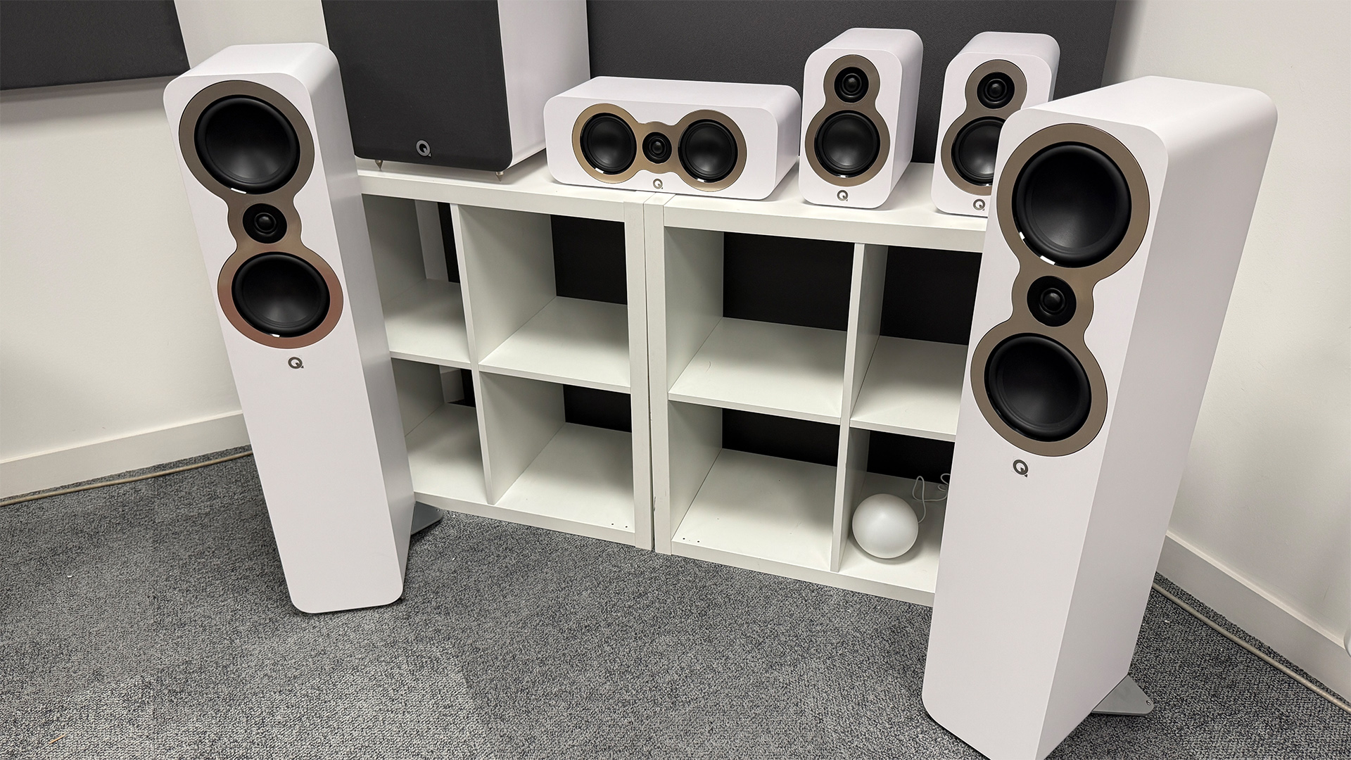 Q Acoustics 3050c 5.1 home cinema speaker package on grey carpet in test room