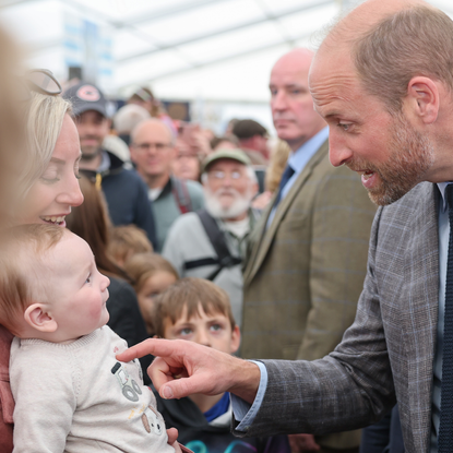 Prince William meeting a baby called George in June 2025 at the Royal Cornwall Show
