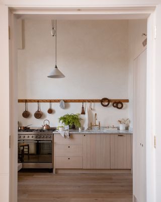 Rustic deVOL kitchen with peg rail pan storage