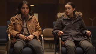 Isabela Merced's Dina and Bella Ramsey's Ellie sitting in a room in The Last of Us season 2