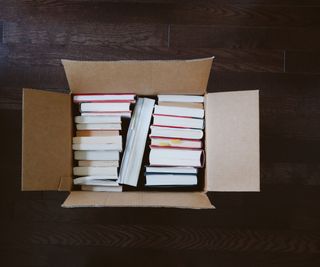 A cardboard box full of books