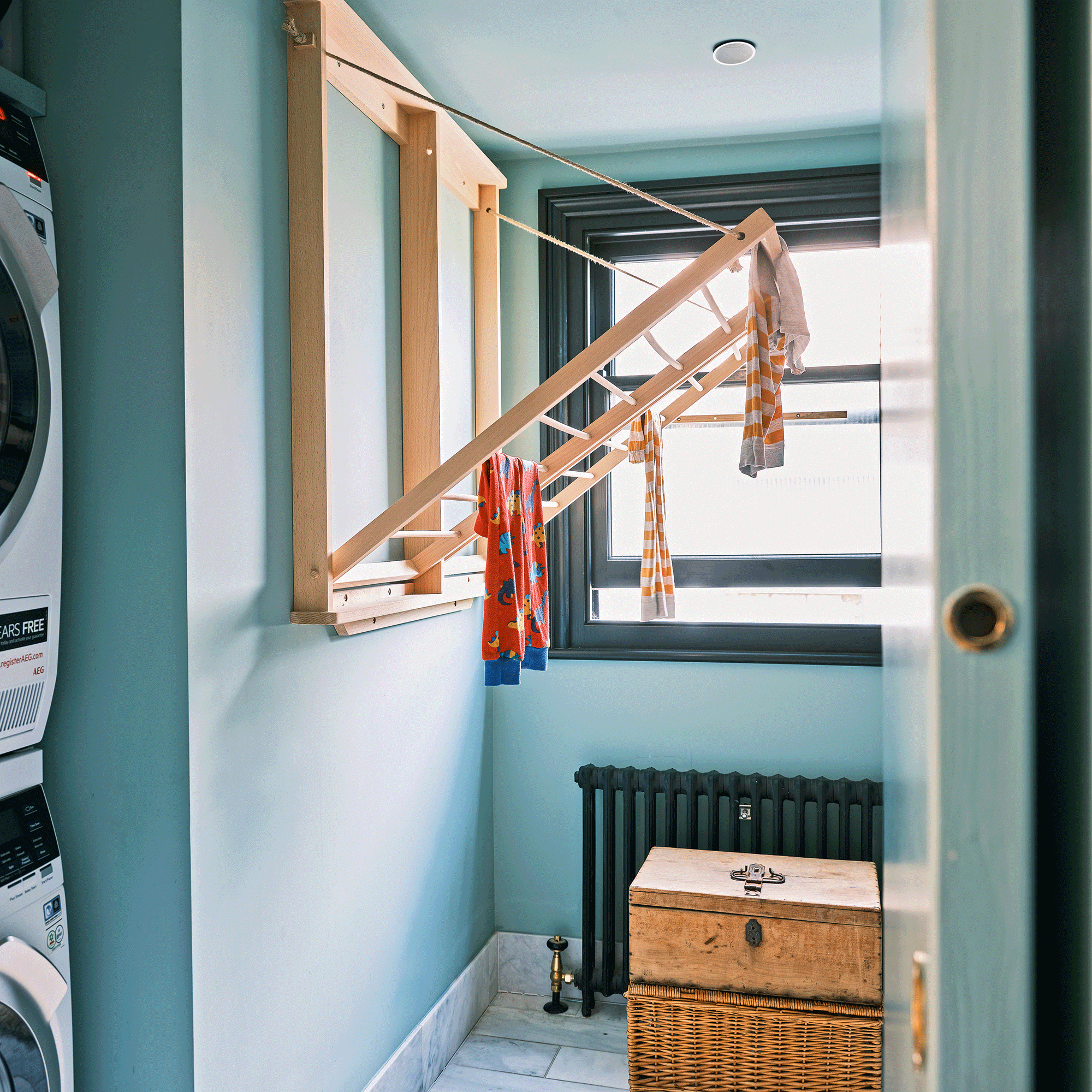 Blue utility room with wooden hanging rack