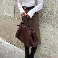 @iliridakrasniqi carrying a brown leather The Row Margaux bag