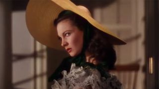 Vivien Leigh in antebellum hat and green dress in Gone with the Wind scene.