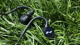 NuraLoop workout earbuds on some grass