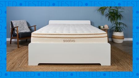 A Saatva Classic mattress on a bed frame in our Sleep Lab. A blue background with the word 'tested' surrounds it