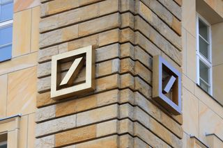 Deutsche Bank logo attached to a yellow-brick wall