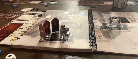 Tokens and markers on the Divinity Original Sin: The Board Game book