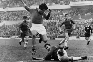 Omar Sivori (of Italy and Argentina) leaping over Elsener (of Switzerland) during a World Cup match between Italy and Switzerland