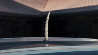 A unicorn horn protruding from a car roof in Death of a Unicorn