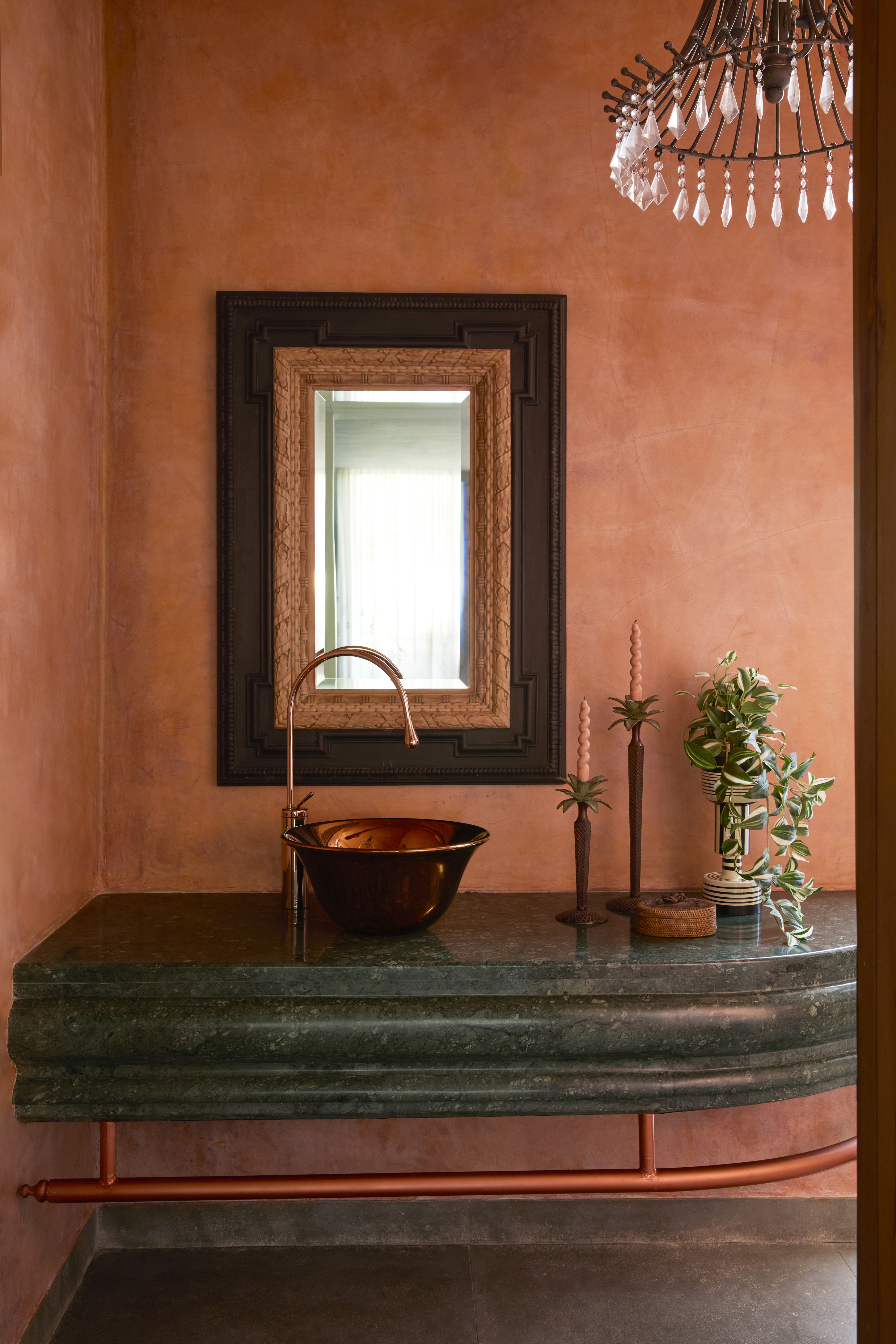 Bathrooms designed in vibrant orange and green tones, using tactile materials