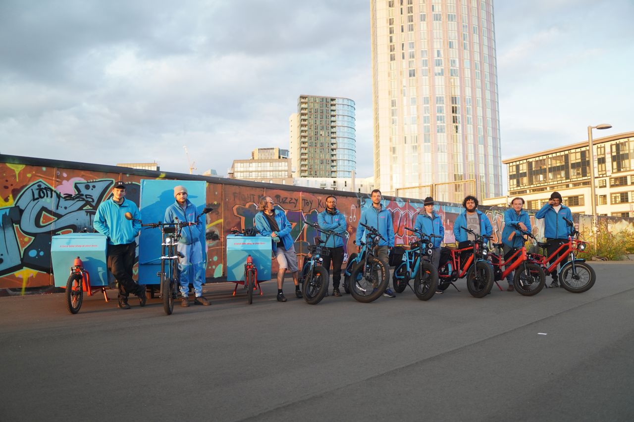 A group of men stand with bikes