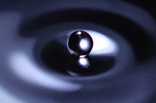 A drop of fluid striking the surface of a fluid bath