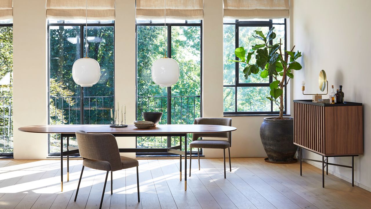 A mid-century style living room with wood flooring and large windows