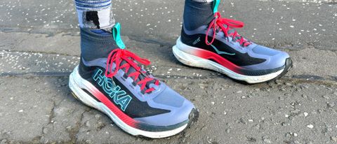 Person wearing the Hoka Tecton X3 trail running shoes outside