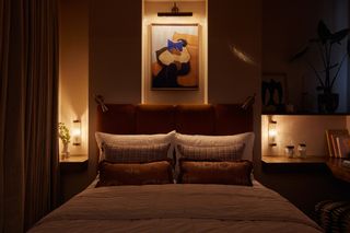 A bedroom with layered lighting