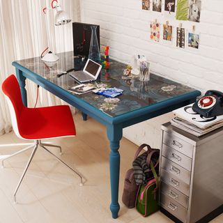 room with white painted brick wall and painted blue desk and red chair