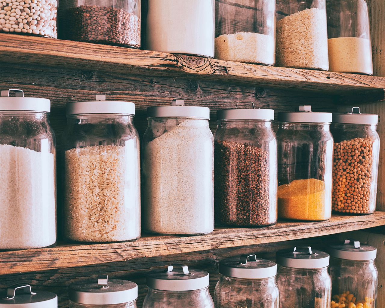 how to get rid of moths - jars of loose produce ingredients in a pantry - getty