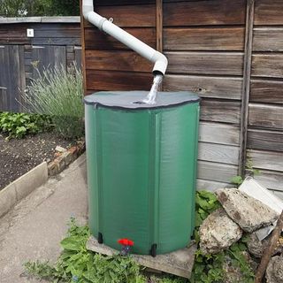 Water barrel in green with water flowing
