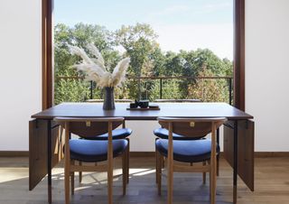 A small dining room with an extendable table