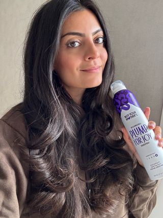 Michelle Rostamian's shiny hair is thanks to the Not Your Mother's Plump For Joy Volumizing Hairspray.