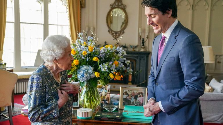 Britain's Queen Elizabeth II (L) speaks with Canadian Prime Minister Justin Trudeau during an audience at the Windsor Castle, Berkshire, on March 7, 2022.