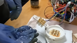 An electro-active polymer (EAP) hydrogel alongside the electrode array being used to &quot;teach&quot; it how to play Pong.