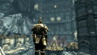 Best Skyrim mods — A Dwemer-armored adventurer looks out at a subterranean ruin in the Forgotten City mod.