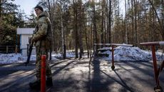 A member of the Ukrainian State Border Guard stands watch at the border crossing between Ukraine and Belarus on Feb. 13 in Vilcha, Ukraine.