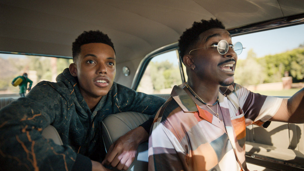 Jabari Banks as Will, Jordan L. Jones as Jazz, in a car together, with Jazz driving and Will in the back seat leaning forward