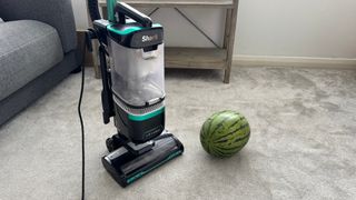 A watermelon next to a vacuum