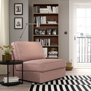 A pink single sleeper sofa