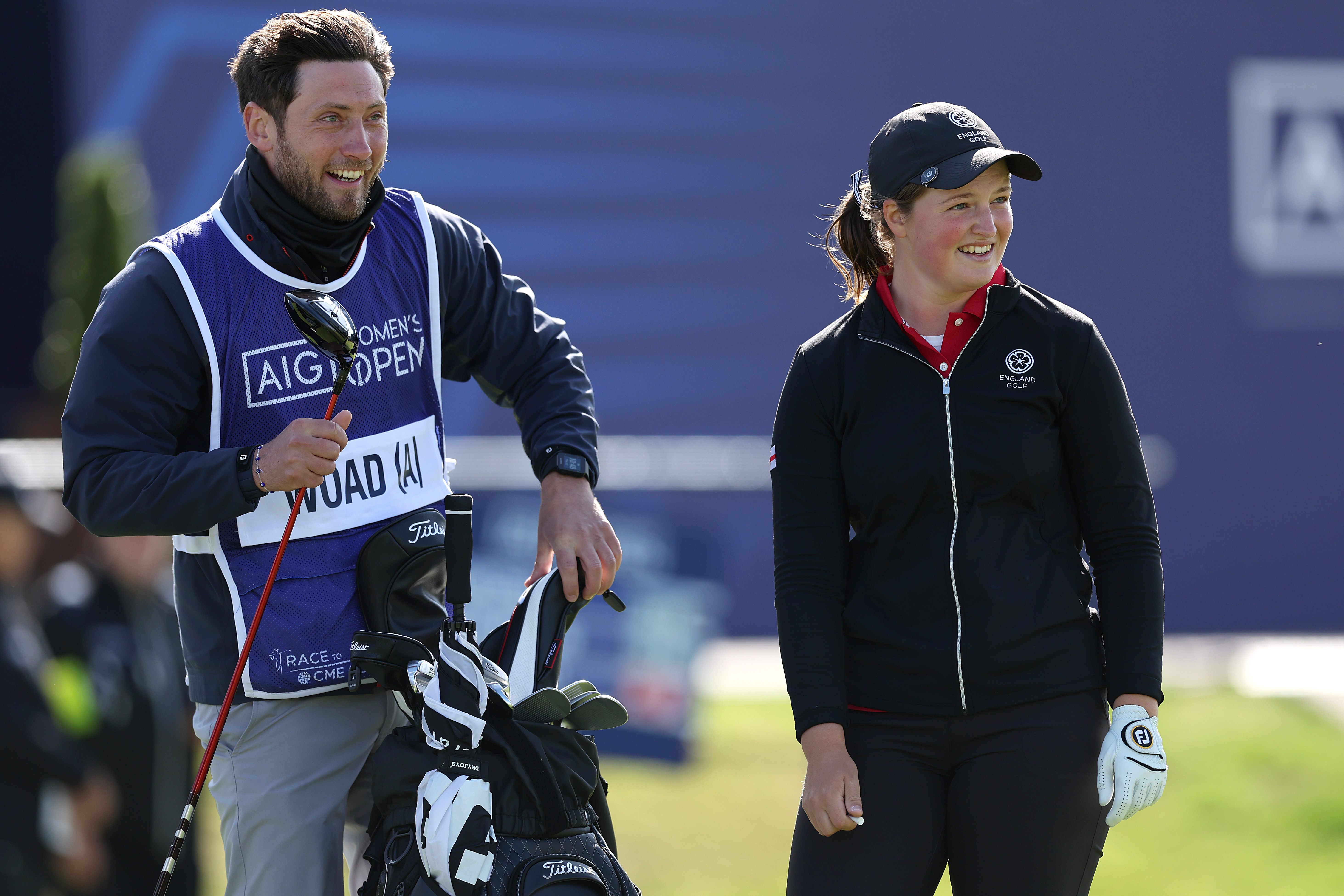 - who served as her caddie during the 2024 AIG Women's Open at St Andrews - look on while smiling
