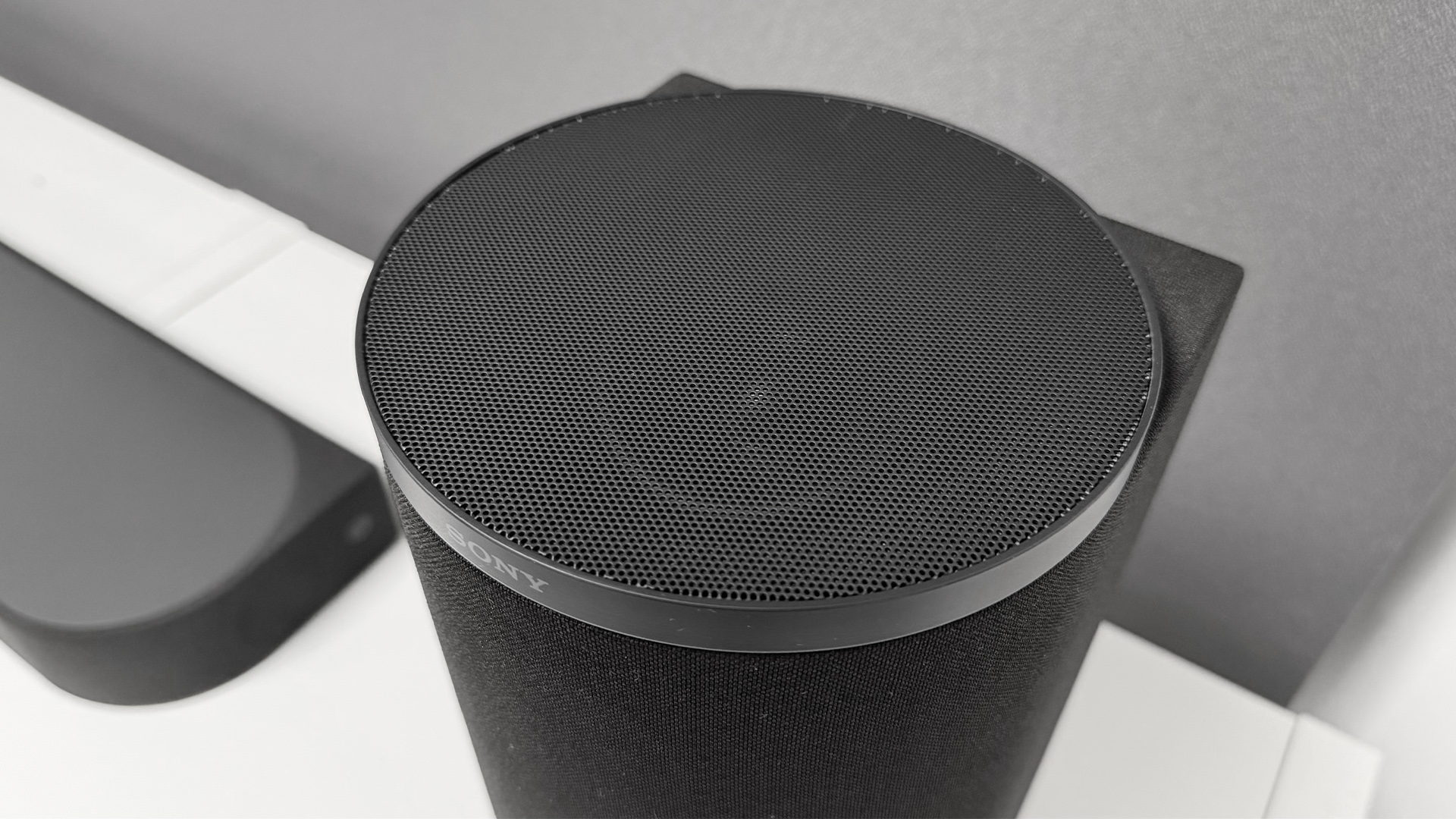Sony Bravia Theatre Trio Dolby Atmos soundbar on white surface detail of side speaker
