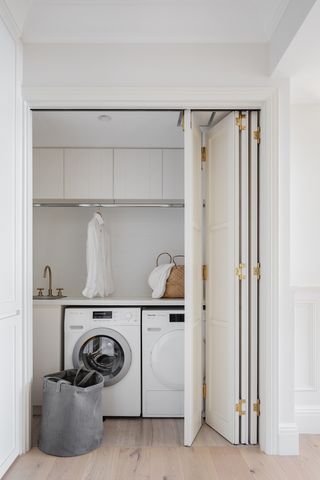 narrow utility room ideas using a folding door to hide a laundry area