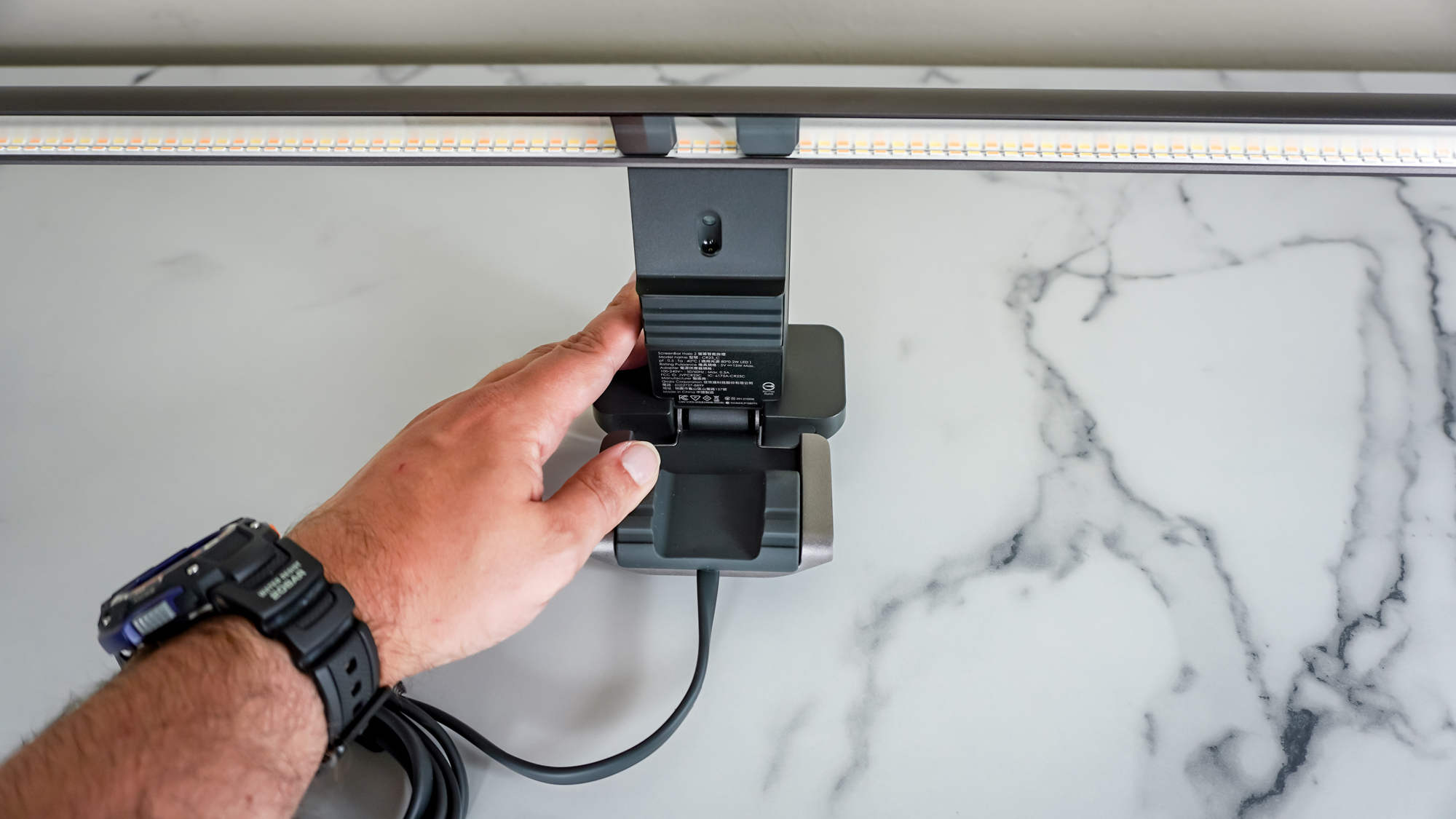 An overhead view of the BenQ ScreenBar Halo 2 on a desk showing off is new ultrasonic motion sensor