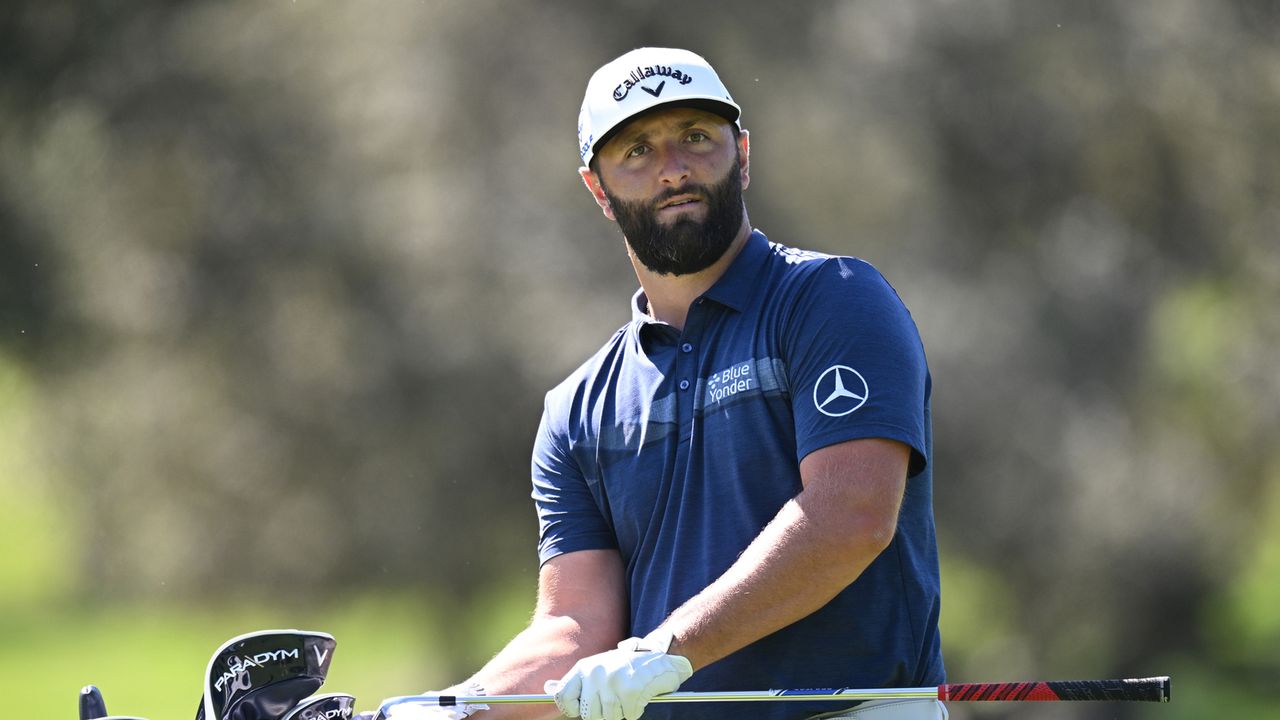 Jon Rahm looks forward as he cleans his club at the 2023 Open de Espana